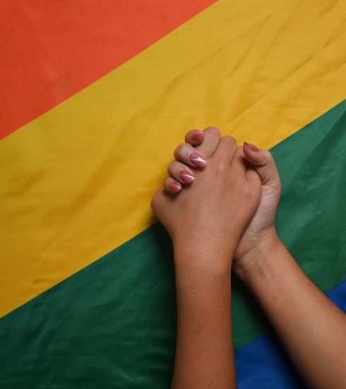 Young asian women LGBT lesbian couple holding hands over LGBT pr