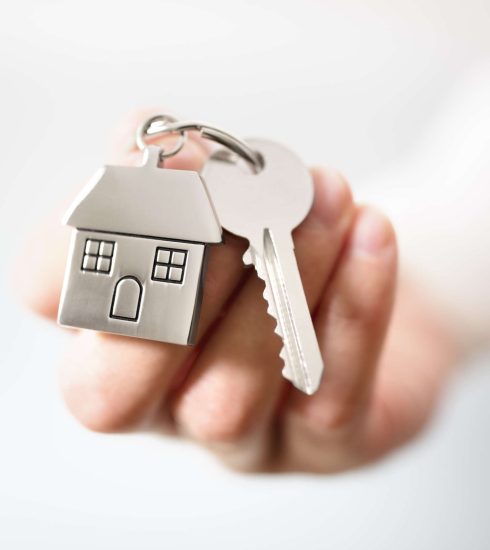 Real estate agent giving house keys
