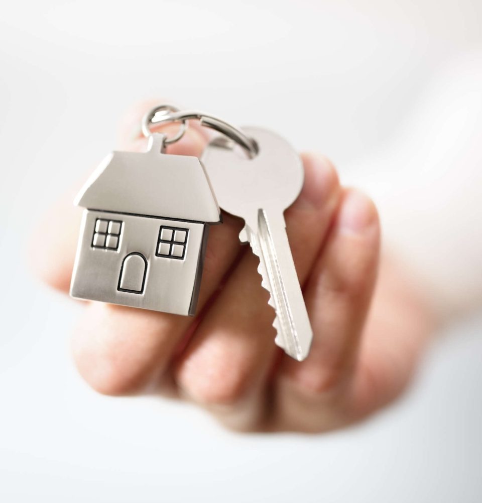 Real estate agent giving house keys