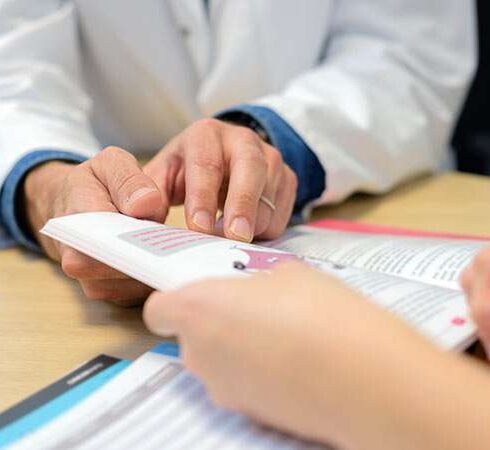 Doctor showing booklet to patient 733x450 1